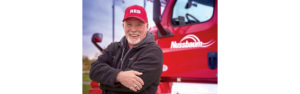 Clark Reed posing next to his Nussbaum semi truck