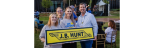 J.B Hunt employees holding J.B. Hunt sign