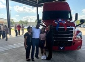 Ondrae Meyers and his family with the freightliner Cascadia truck he received from Progressive's keys to progress program