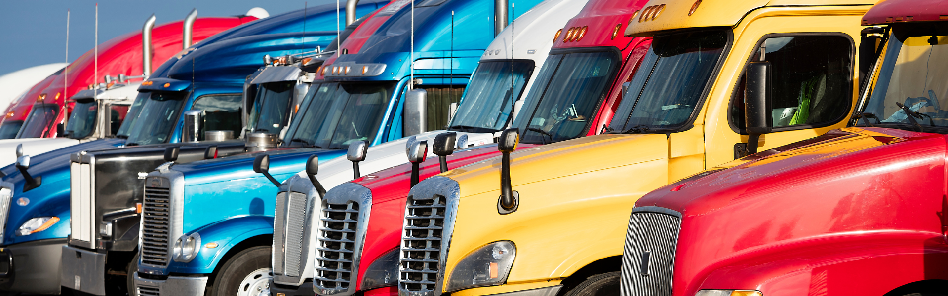 Semi trucks parked in a line. Don't miss the upcoming truck shows that every enthusiast will love!