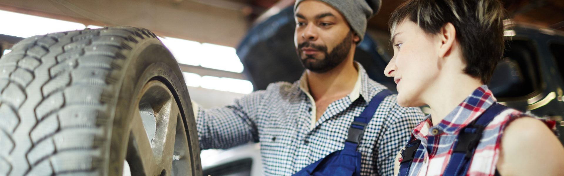 mechanic mentorship, male technician standing next to female technician near tire, The ASE Education Foundation is tackling the automotive industry's technician shortage through mentorship programs