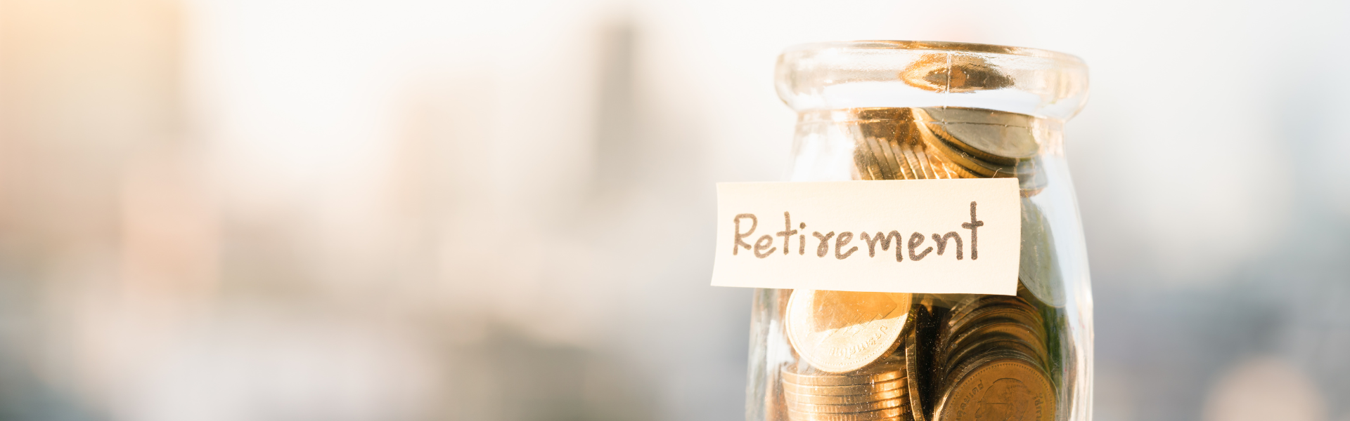 jar of coins marked "retirement" on blurred background , comprehensive retirement planning guide tailored for truck drivers.