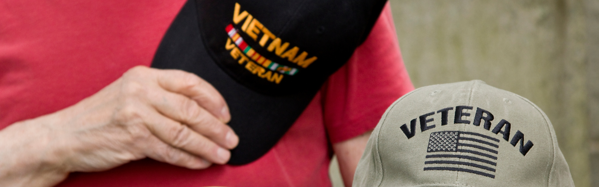 old man holding Vietnam veteran hat with veteran hat sitting in lap. OOIDA’s Truckers For Troops donates $10,000 to the Veterans Community Project in Sioux Falls, supporting their mission to end veteran homelessness