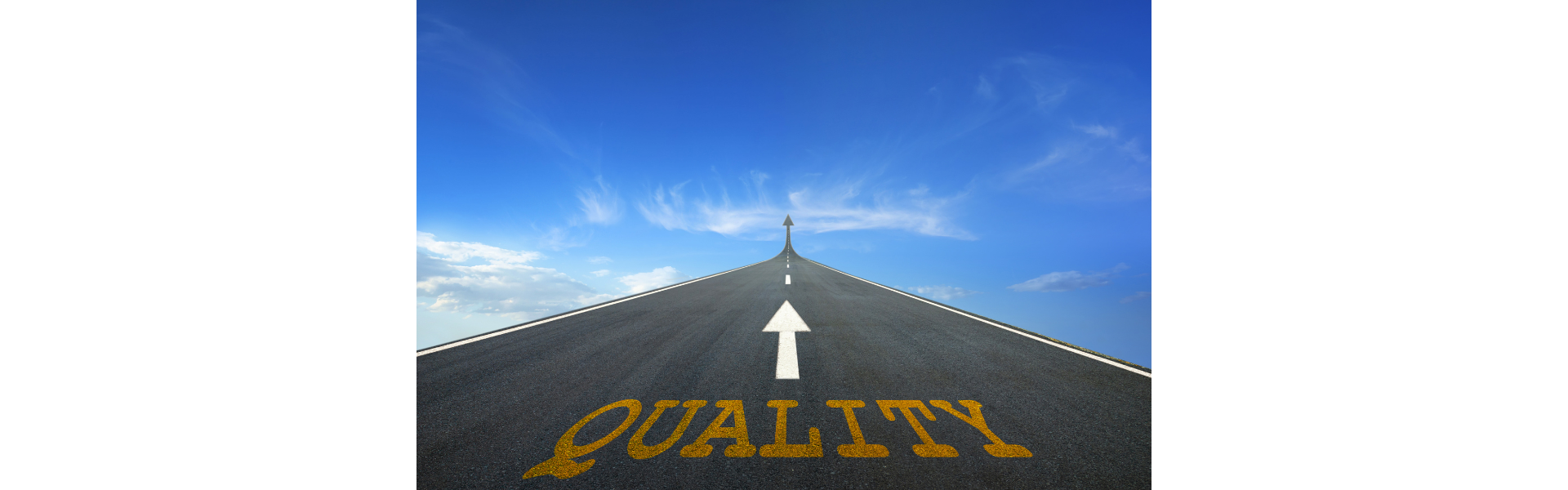 The word "quality" written on the road with an arrow pointing up.