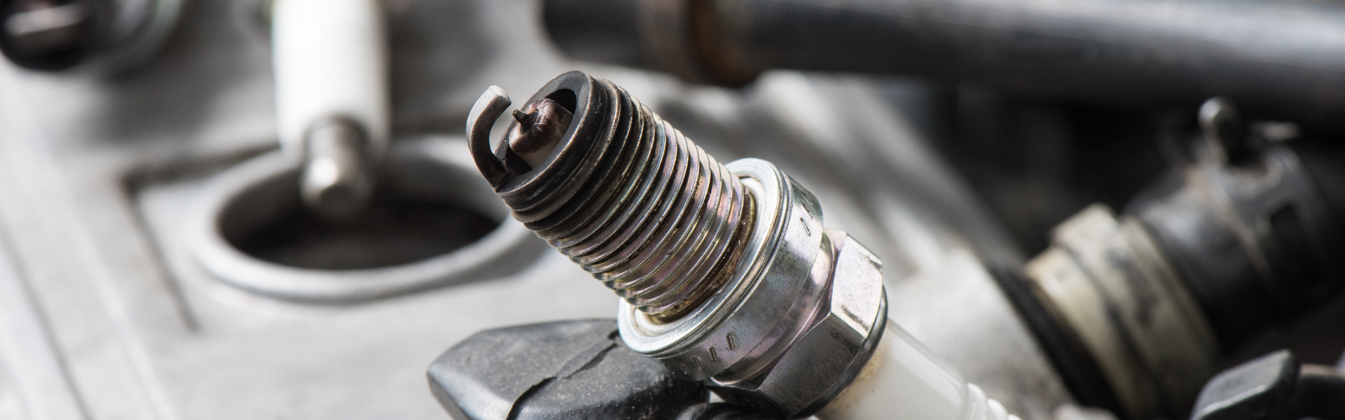 Image of spark plugs. This guide explains the science behind compression ignition, its benefits for truckers, and how diesel engines outperform gas engines in durability, fuel efficiency, and torque—perfect for heavy-duty vehicles.