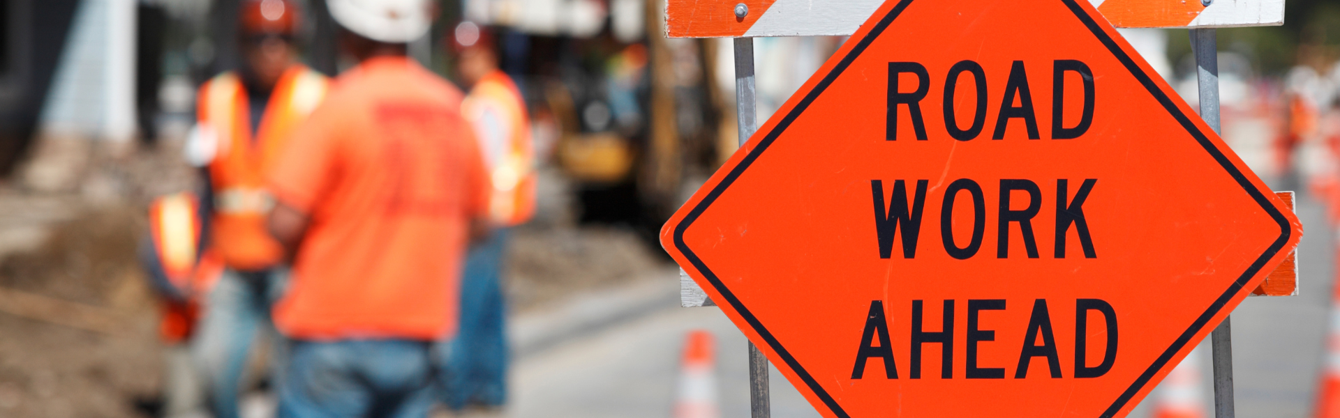 Road work ahead sign signaling I-57 expansion for truck drivers, including faster routes, reduced travel time, and improved efficiency.