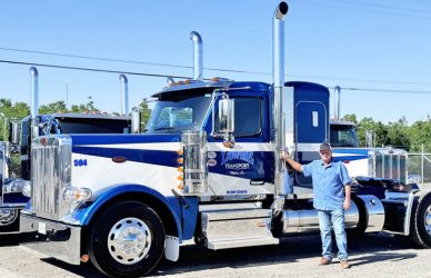 Long-time Peterbilt customer Mike Lowrie, president of Mike Lowrie Trucking in Dixon, Calif., stands next to the 1,000th Peterbilt 589 built by the manufacturer.