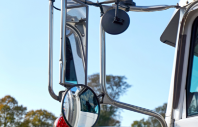 Learn how semi-truck blind spots change during everyday driving, why mirror setup matters, and the techniques professional drivers use to maintain better visibility.