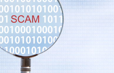 magnifying glass amplifying the word scam among binary code