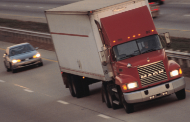 semi truck on highway with cars