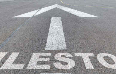 road painted with the word milestone and an arrow
