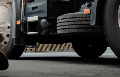 man in work boots walking towards semi truck