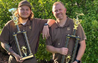 UPS drivers holding National Driving Championship trophies