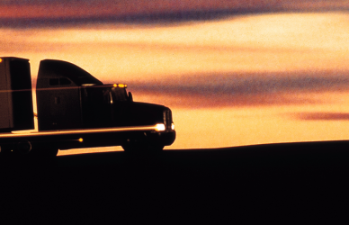 silhouette of semi truck in sunset
