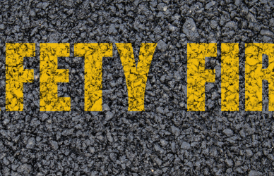 Road with yellow painted words reading safety first