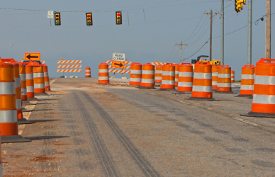 road with orange road construction barrels