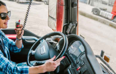 woman in cab of semi truck talking on cb radio