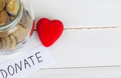 jar of coins with a donate note