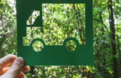 cutout of truck held up to the forest