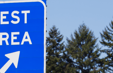 road sign pointing to rest area exit