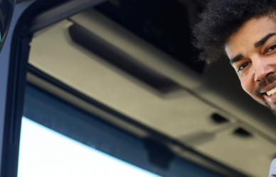 young black man in semi truck cab