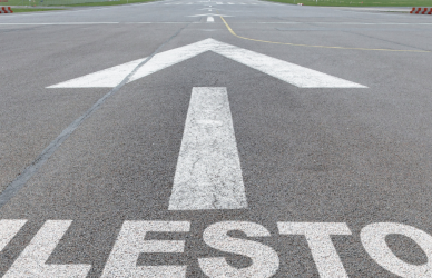 milestone with arrow painted on pavement