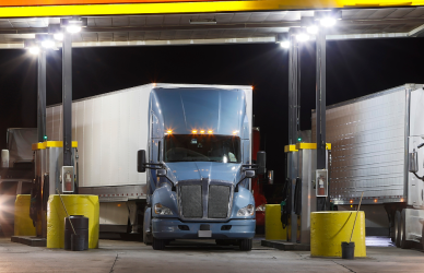 truck stop fuel island at night with semi trucks