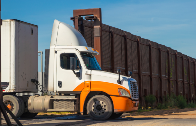 semi truck emerging from border wall