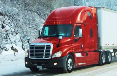red semi truck on snowy road