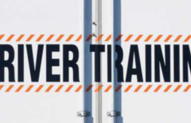 back of semi truck trailer that reads "driver training"