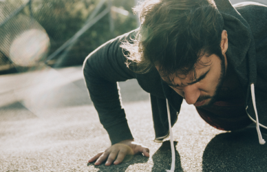 Man doing push ups in parking lot