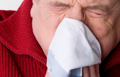 man blowing nose