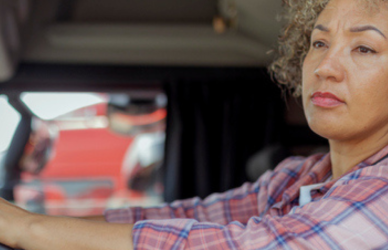 black woman driving semi truck