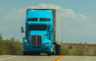 blue semi truck on road