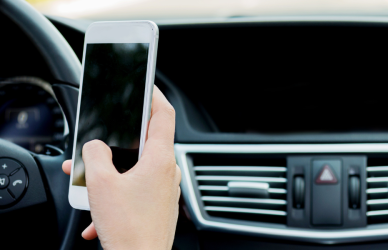 man using phone while driving