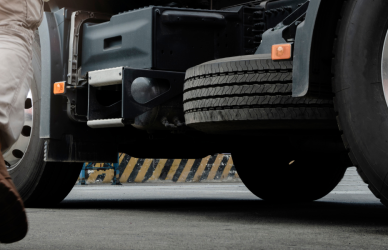 man in work boots walking towards semi truck