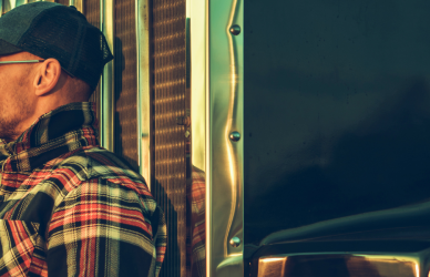 Man leaning against semi truck