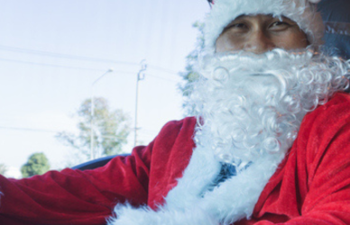 truck driver in semi truck cab dressed as santa