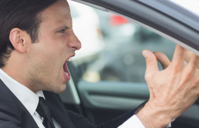 man in business suit with road rage