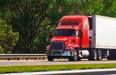 red semi truck driving on road