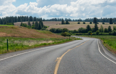 highway with farm fields on either side