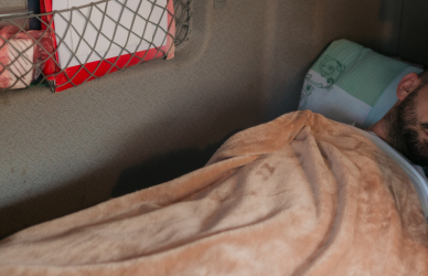 man sleeping in semi truck