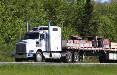 Flat bed semi truck on road