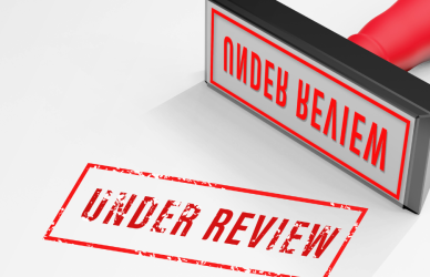 red "under review" stamp