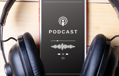 Phone playing podcast with headphones