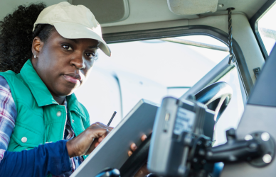 black woman in semi truck cab