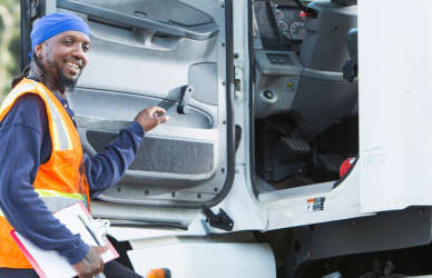 Black man climbing into semi truck cab