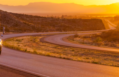 semi truck on interstate at sunset