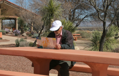 man sitting at picnic table at rest stop