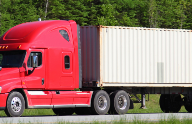 red semi truck with white trailer